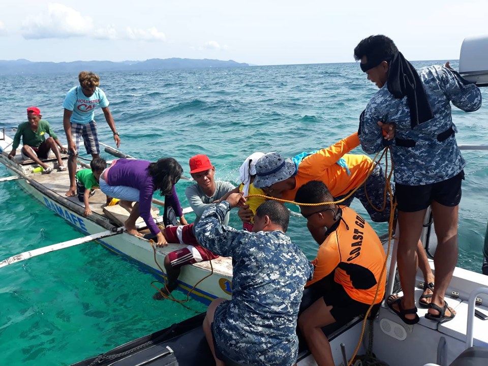 Philippine Coast Guard personnel rescue passengers of a stalled banca off Caluya, Antique. Photo courtesy of Philippine coast guard.
